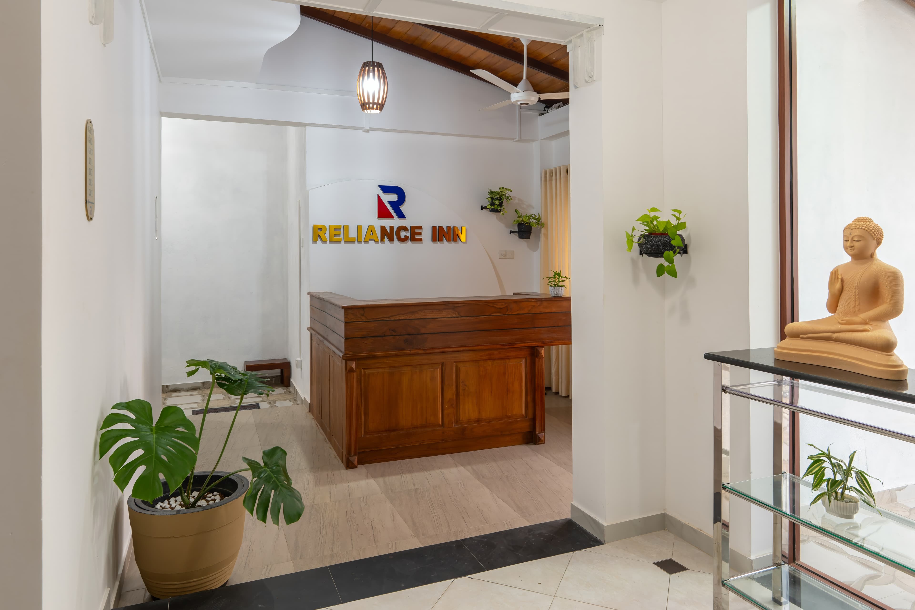 Reception desk with Reliance Inn branding